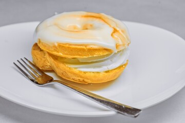Traditional Czech "Větrník" Pastry with White Sugar Glaze on a Plate