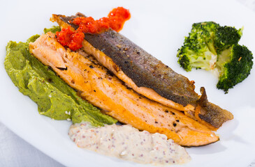 Delicious fried brook trout fillets with broccoli and tartare saucee