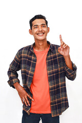 Enthusiastic young man pointing upwards, exuding positivity and showcasing an idea