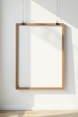 Empty modern frame suspended by clips against a clean white wall, white wall, clip, frame