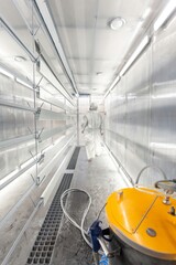 man painting parts in powder coating booth