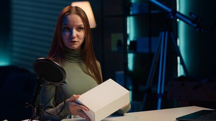 Content creator filming technology review of various electronics, unboxing them and presenting...