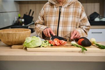 Person Preparing a Fresh and Healthy Vegetable Salad in a Modern Kitchen
