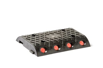 Fototapeta premium Versatile Rubber Speed Bump with Reflective Elements for Enhanced Road Safety in High-Traffic Areas Ideal for Use in Parking Lots, Driveways, and Sidewalks