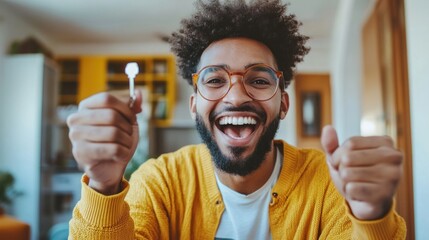 Excited tenant displaying apartment keys with joyous expression and thumbs up
