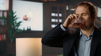 Classy high society member enjoying a glass of whiskey bourbon in a private social club, emphasizing the sophisticated upper class lifestyle and entertainment. Old money luxury. Camera A.