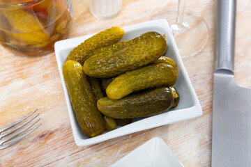 Little pickled cucumbers gherkins on plate, homemade pickles