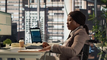 Female boss with chronic disability examining archived files and data reports, creating a financial...