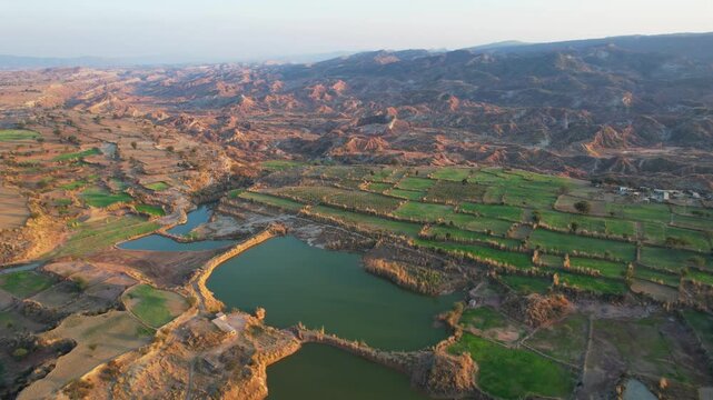 Aerial view of village between hills in Chakwal, Pakistan.
