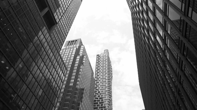 Gaze upward to discover stunning skyscrapers showcasing impressive architecture in a bustling city. The combination of glass and steel creates a striking skyline impression.