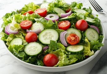 Fresh and Vibrant Salad with Green Lettuce, Red Tomatoes, Cucumbers, Red Onion, and Healthy Vegetables in Bright Bowl on Marble Table