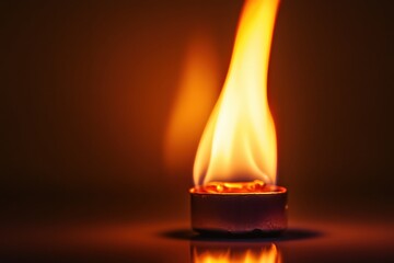 A candle flame is glowing bright with warmth and light