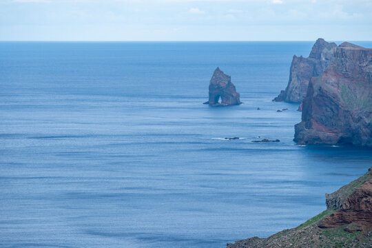Viewpoint Calhau da Furna do Bode on Madeira, green hills meet sea, discovery archipelago landscape, volcanic island travel, adventure vacation, colorful rooftops, Madeira, Portugal