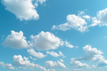 Obraz premium A Fluffy white clouds drift across clear blue sky, creating serene and peaceful atmosphere that invites relaxation and contemplation