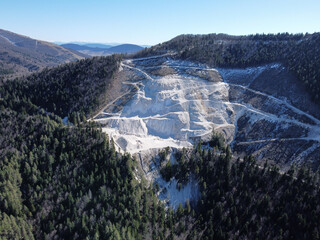 Stone quarry mine, aerial drone view. Open pit mine. Mining of the quarry. excavating stone and rocks. Mineral excavation in nature. 