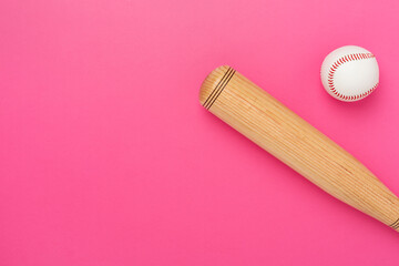Wooden baseball bat on color background, top view