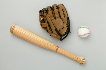 Baseball glove and bat with ball on color background, top view