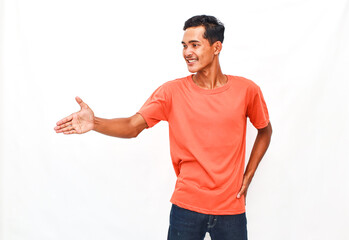 Smiling Person in Orange Shirt Offering Handshake Against White Background