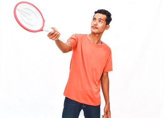 Young Man In Orange Shirt Holding Pest Control Device Against White Background