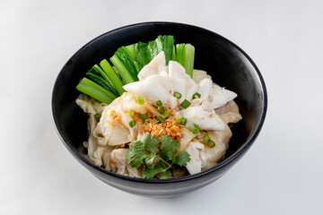 chinese egg noodle in bowl with slice red roasted pork, pork's wontons and white crab meat on it.