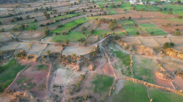 Aerial view of village between hills in Chakwal, Pakistan.