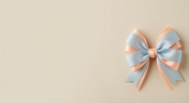 Blue and peach satin bow with elegant loops on soft beige background representing celebration and decoration