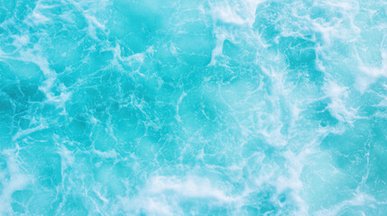 Fototapeta premium Aerial view of turquoise ocean water with gentle waves and foam, creating serene and calming atmosphere