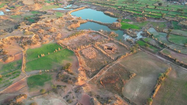 Aerial view of village between hills in Chakwal, Pakistan.