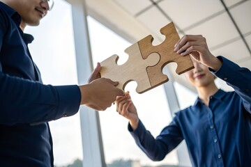 businessman holds in hand a jigsaw puzzle for partnership teamwork, collaborate of partner and alliance or business connection. Business solutions, success and strategy concept.