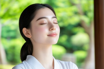 Serene woman with eyes closed enjoys peaceful moment outdoors