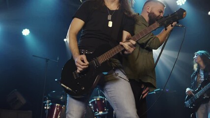 Rock band performing live on stage in slow motion