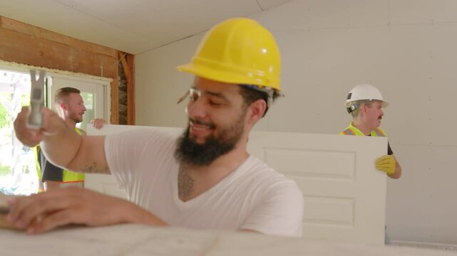 A diverse team of skilled builders is actively collaborating on an exciting renovation project at a busy construction site, effectively showcasing their teamwork and shared expertise in the field