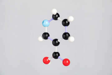 Molecule of niacin (vitamin B3) on light grey background. Chemical model