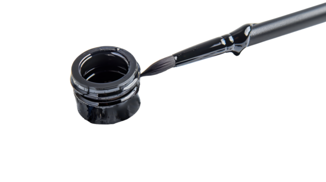 Brush picking up black ink from open jar on transparent background