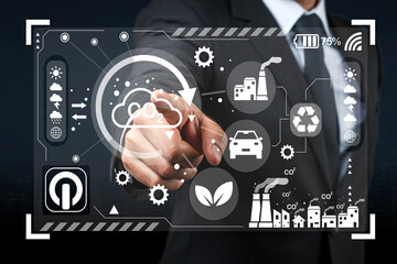 Businessman using a futuristic touchscreen interface to analyze environmental data, showcasing eco-friendly technology and industrial insights in a digital format