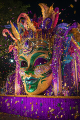 colorful mardi gras parade float with mask and confetti
