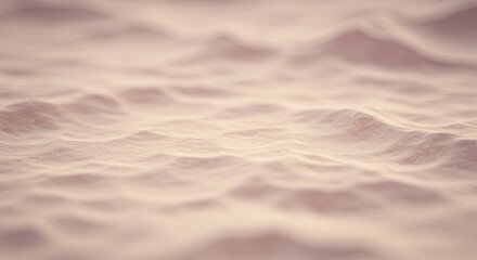 Obraz premium The image is a close up of a sandy beach with a wave in the background