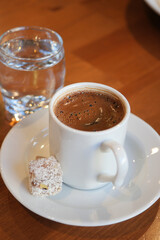 turkish Coffee served with sweet treat and water in cozy setting