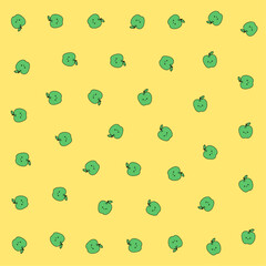 a pattern of green apples on a yellow background