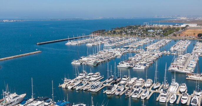 Aerial view of Chula Vista Marina filled with boats docked in rows, showcasing recreational boating and maritime activity in San Diego, California, USA. - Powered by Adobe