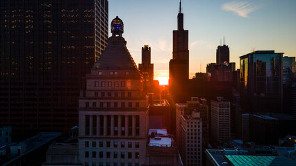 Chicago's Majestic city skyline at sunset, with golden light illuminating skyscrapers and casting...