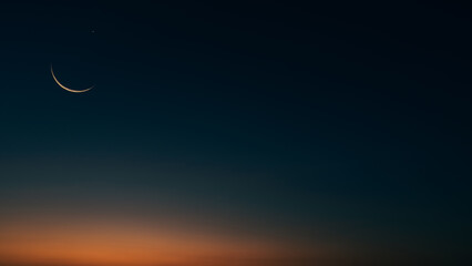Islamic Moon sky on Dark Blue Dusk,Twilight Sky in the Evening with Sunset and Beautiful Sunlight dark cloud and Crescent moon, symbol of religion islamic begin Ramadan month, Eid al-Adha, Eid al fitr