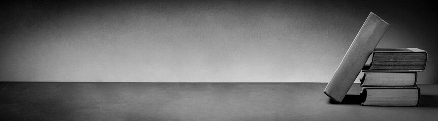Stack of Vintage Books on Minimalist Background in Black and White Tone