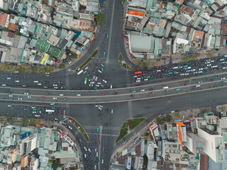 Aerial Top View of a Bustling Intersection in Ho Chi Minh City at Sunset with Chaotic Traffic