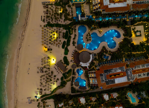 A beach with a hotel and pool area