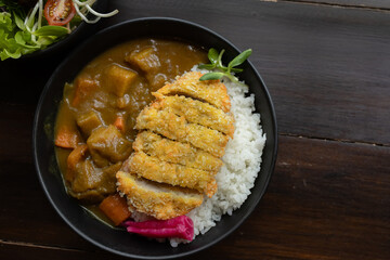 Japanese food is placed on wooden tables inside a restaurant