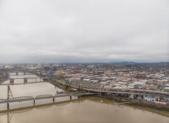 Fototapeta premium A city with a river running through it and a bridge over it