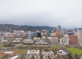 A cityscape with a cloudy sky and tall buildings