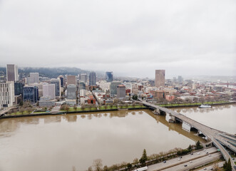 Fototapeta premium A city with a river running through it and a bridge over it