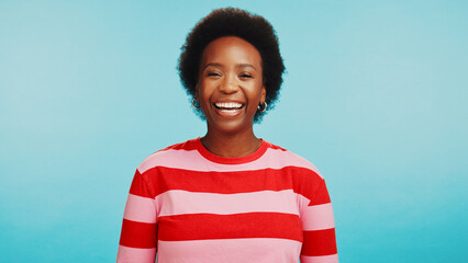 Happy, laughing and portrait of black woman in studio for joke, comedy and silly with mockup space....